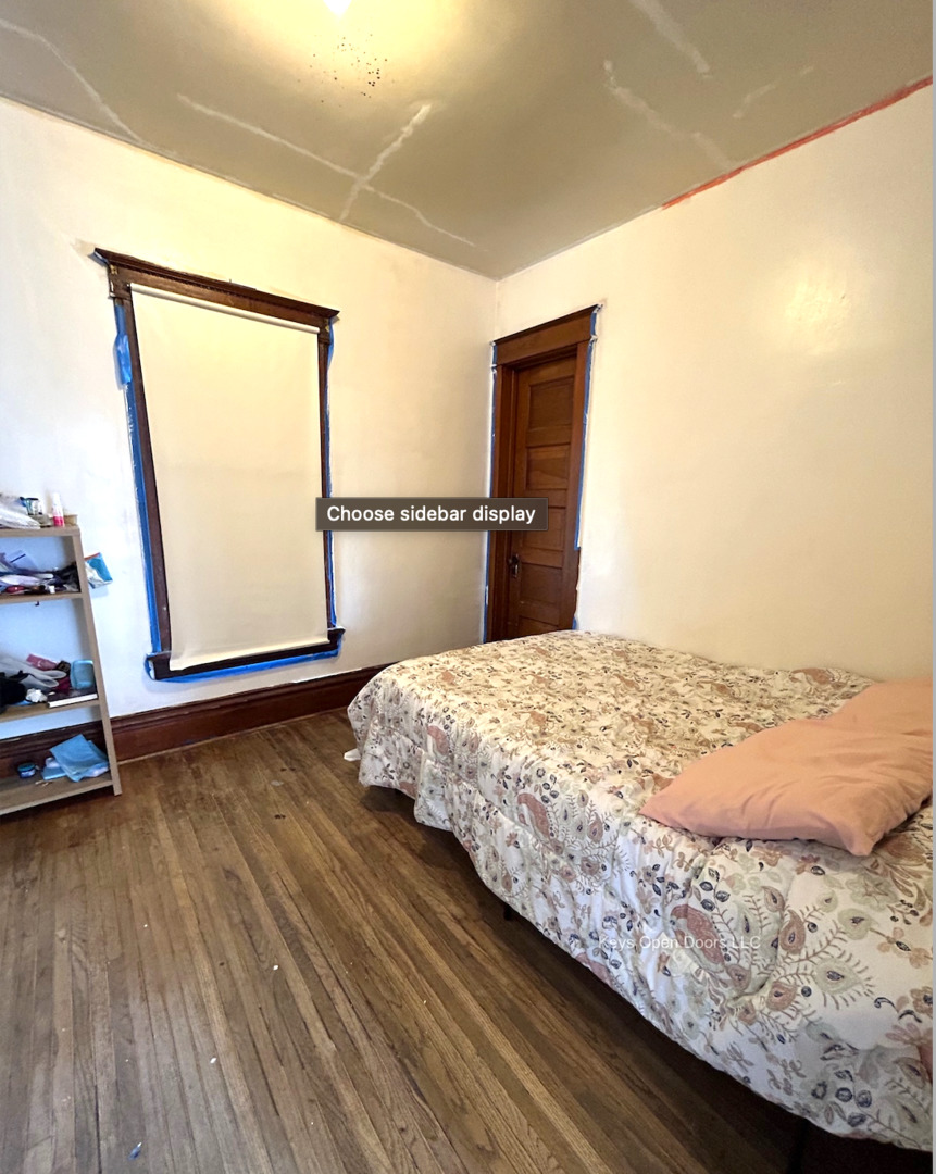 509 Fifth Street Aurora, IL 60505 - Photo 12 of 14 a bedroom with a bed and wooden floor