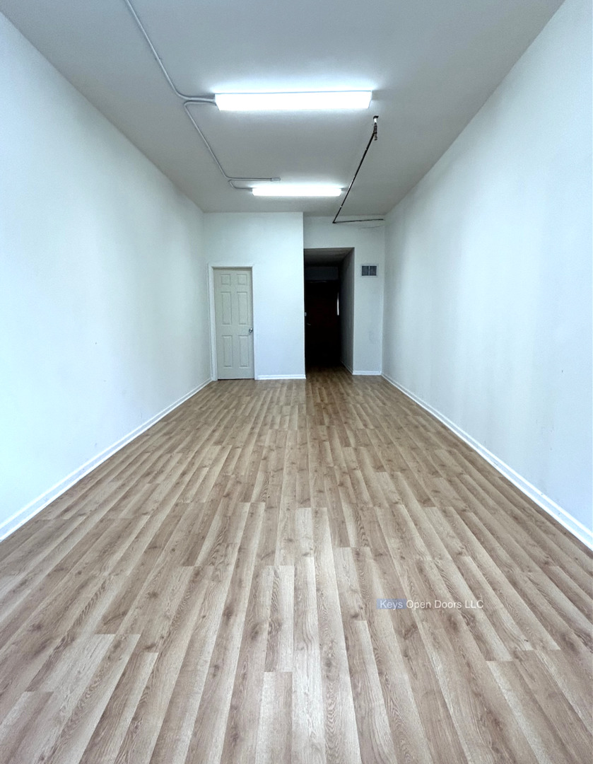 509 Fifth Street Aurora, IL 60505 - Photo 4 of 14 an empty room with wooden floor and windows