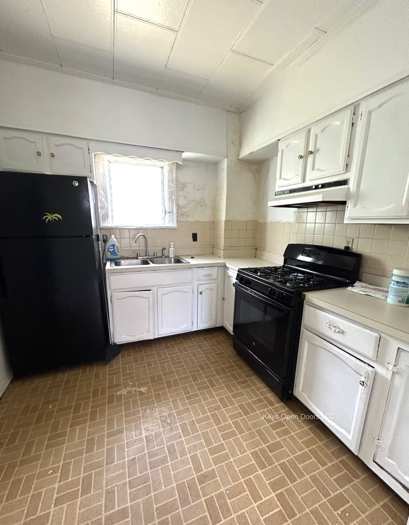 509 Fifth Street Aurora, IL 60505 - Photo 9 of 14 a kitchen with a sink a stove and refrigerator