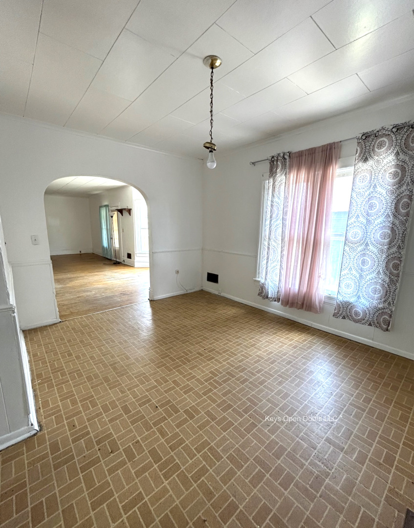 509 Fifth Street Aurora, IL 60505 - Photo 10 of 14 an empty room with wooden floor and windows
