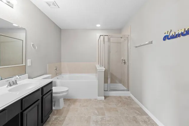 a bathroom with a tub sink toilet and a mirror