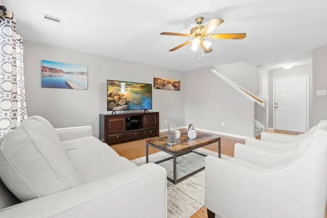 a living room with furniture and a flat screen tv