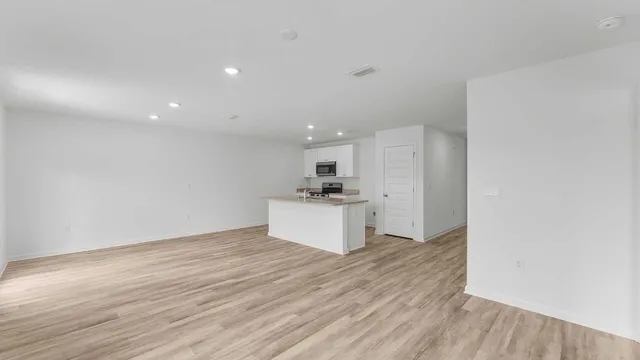 a view of kitchen with kitchen island microwave and stove