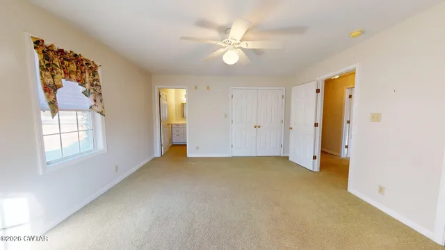 an empty room with windows and closet