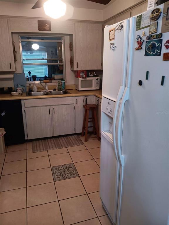 4245 Edgewater Drive Orlando, FL 32804 - Photo 17 of 44 a kitchen with stainless steel appliances granite countertop a refrigerator and a stove