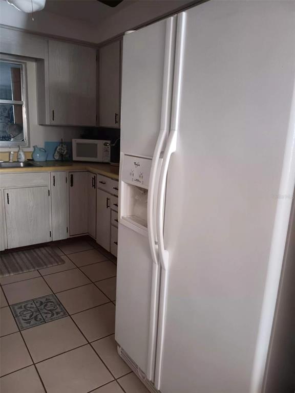 4245 Edgewater Drive Orlando, FL 32804 - Photo 18 of 44 a kitchen with stainless steel appliances a refrigerator and cabinets