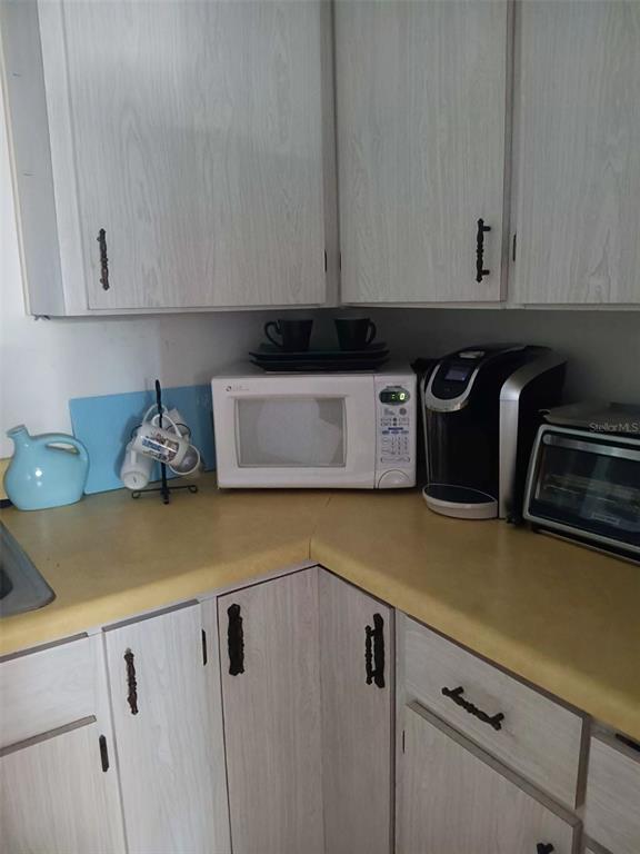 4245 Edgewater Drive Orlando, FL 32804 - Photo 19 of 44 a kitchen with a sink and cabinets