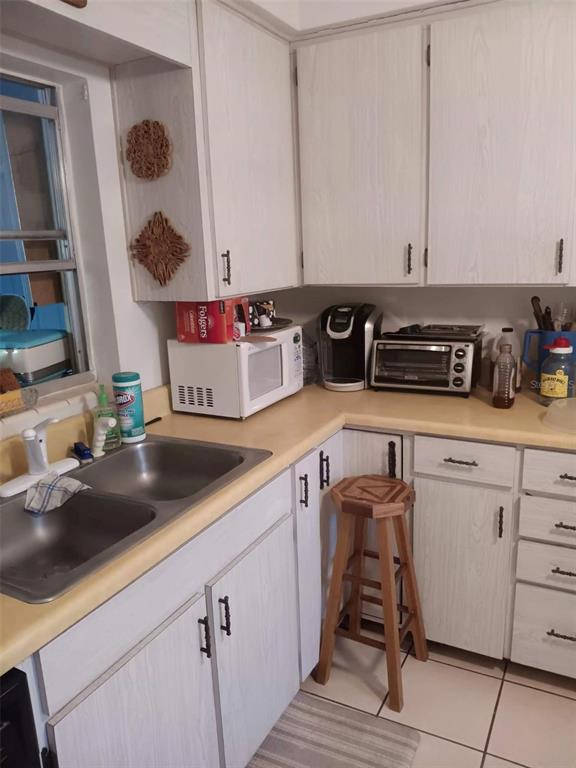 4245 Edgewater Drive Orlando, FL 32804 - Photo 21 of 44 a kitchen with a sink a stove and cabinets