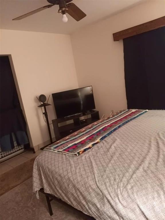 4245 Edgewater Drive Orlando, FL 32804 - Photo 32 of 44 a bedroom with a bed and a flat screen tv