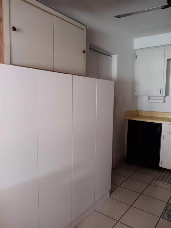 4245 Edgewater Drive Orlando, FL 32804 - Photo 39 of 44 a kitchen with a refrigerator and a sink