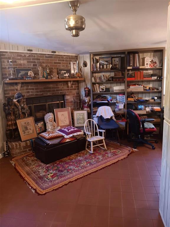 4245 Edgewater Drive Orlando, FL 32804 - Photo 5 of 44 a living room with furniture and a bookshelf