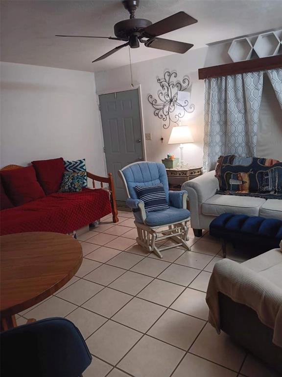 4245 Edgewater Drive Orlando, FL 32804 - Photo 10 of 44 a living room with furniture and a window