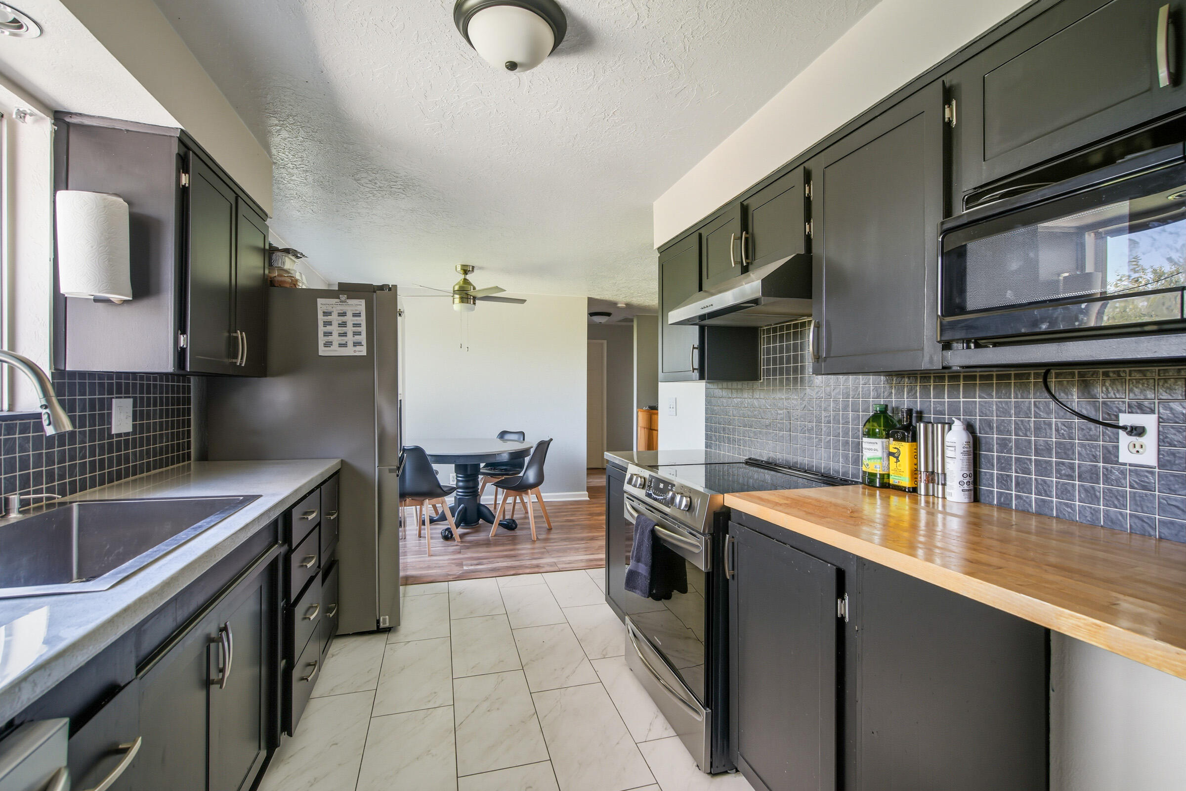664 Southwest 35th Street Redmond, OR 97756 - Photo 7 of 19 a kitchen with stainless steel appliances granite countertop a sink stove and refrigerator