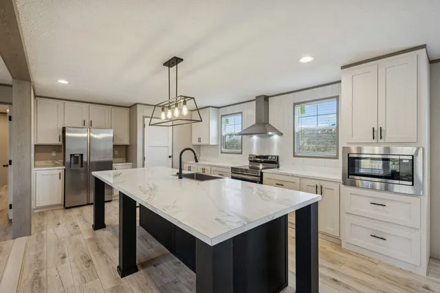 a view of a kitchen with wooden floor and a sink