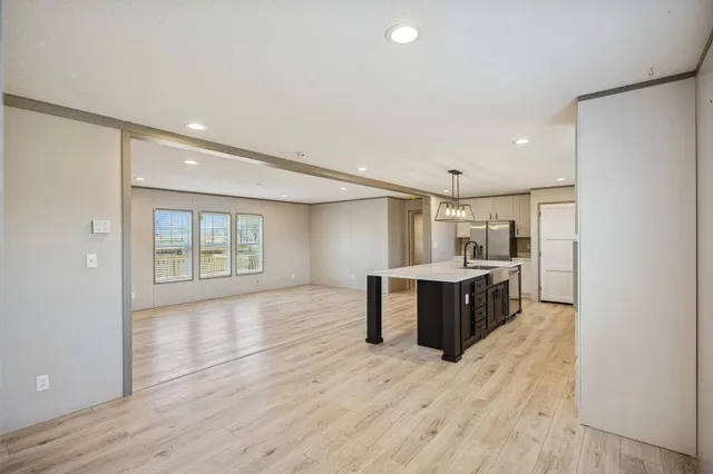 a view of a hallway with wooden floor and closet