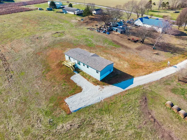 an aerial view of a house with a yard