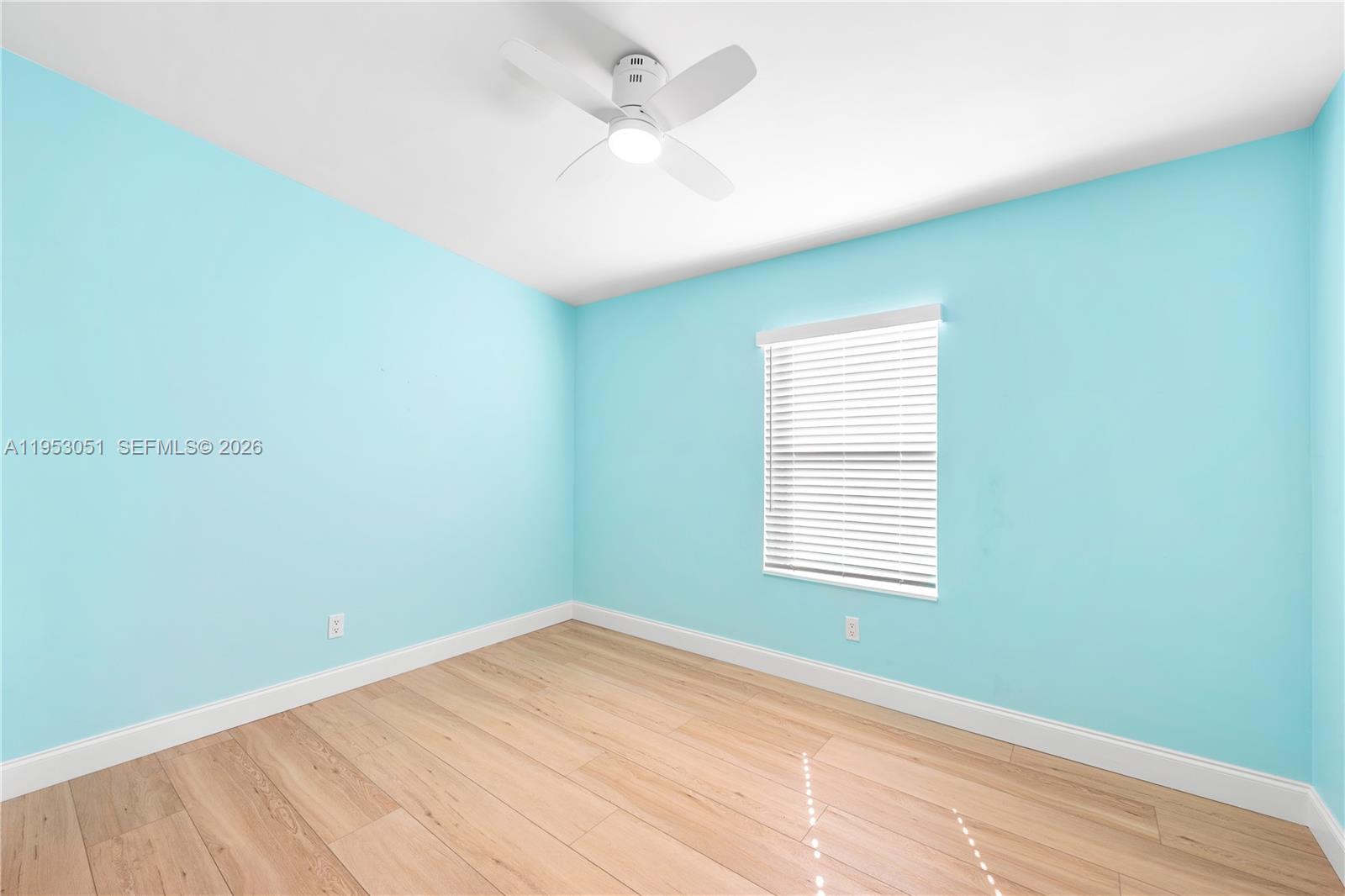 5611 Southwest 32nd Terrace Dania Beach, FL 33312 - Photo 12 of 29 an empty room with a window and a ceiling fan
