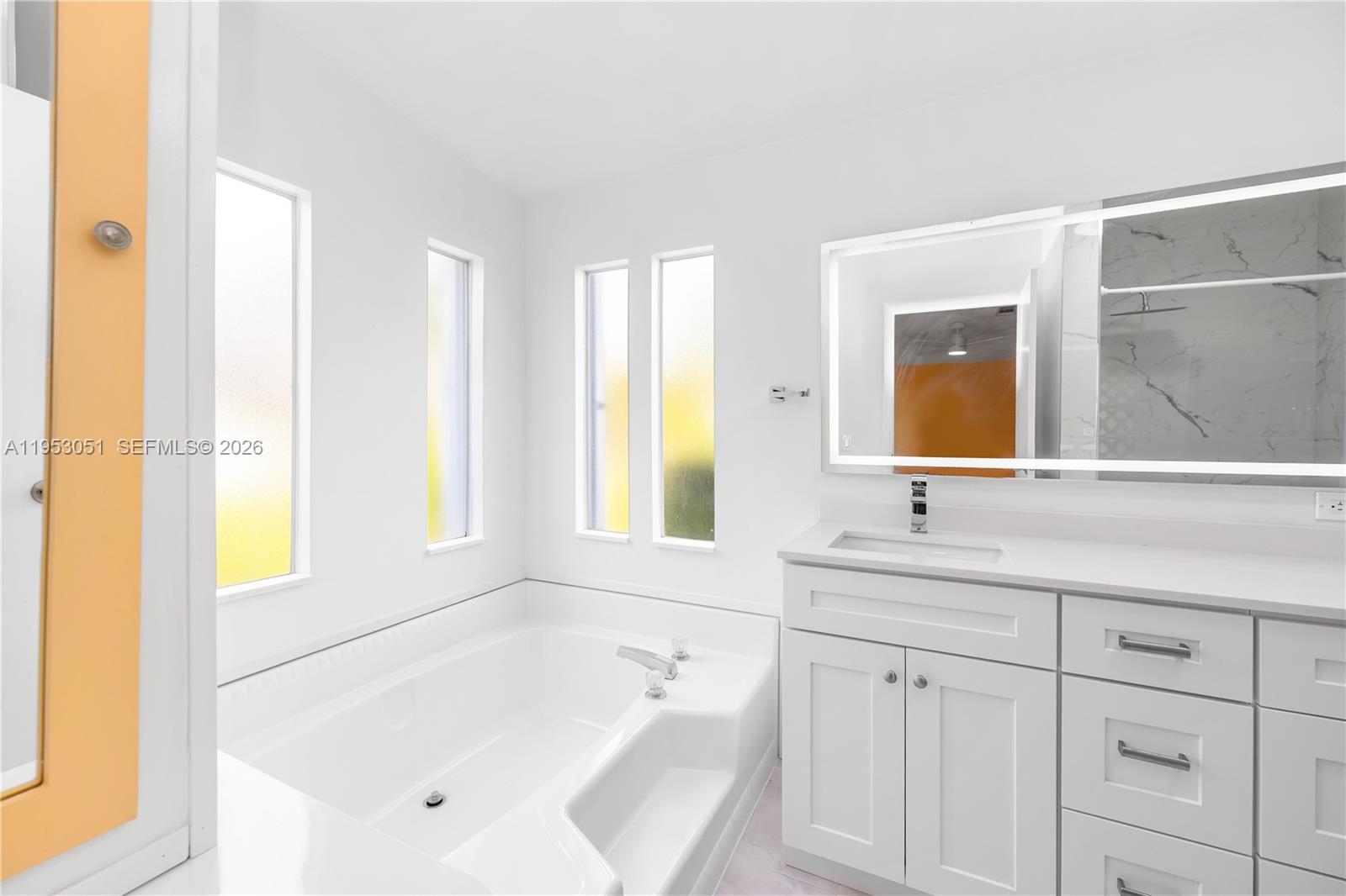 5611 Southwest 32nd Terrace Dania Beach, FL 33312 - Photo 19 of 29 a bathroom with a tub sink and mirror