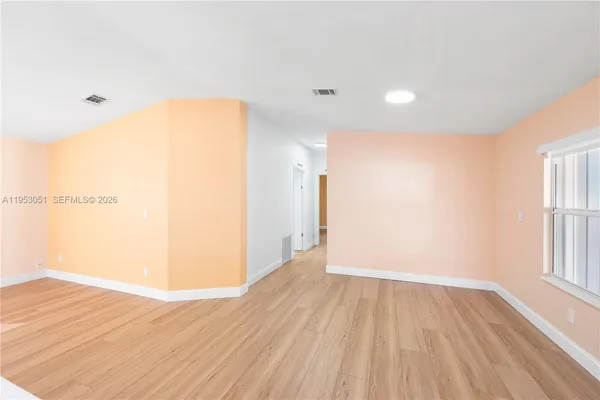 a view of a room with wooden floor