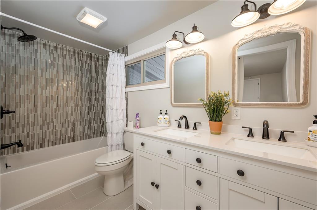 146 Shannon Road Renfrew, PA 16053 - Photo 12 of 25 a bathroom with a toilet a sink a tub and a mirror