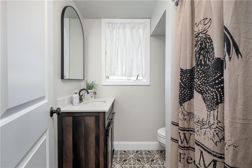 146 Shannon Road Renfrew, PA 16053 - Photo 21 of 25 a bathroom with a sink and mirror with toilet