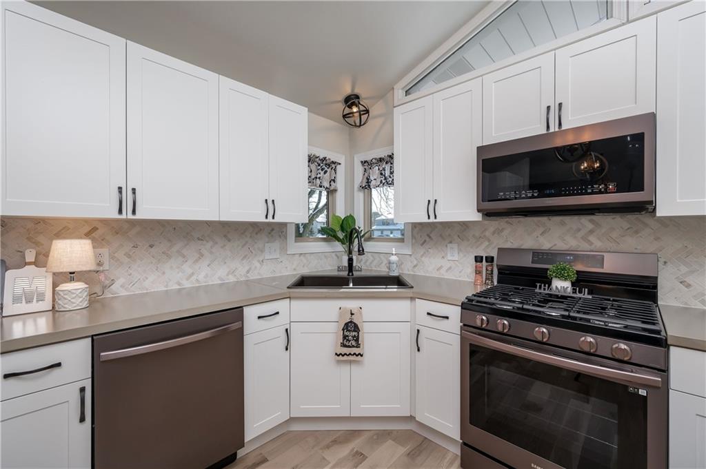 146 Shannon Road Renfrew, PA 16053 - Photo 7 of 25 a kitchen with cabinets stainless steel appliances a sink and a microwave
