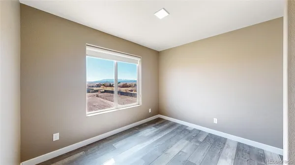 a view of a room with wooden floor and windows
