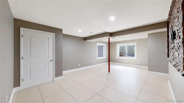 an empty room with closet and a window