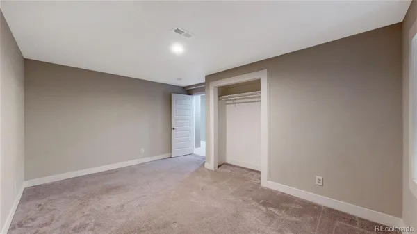 a bathroom with a granite countertop sink toilet a large mirror a bathtub and shower