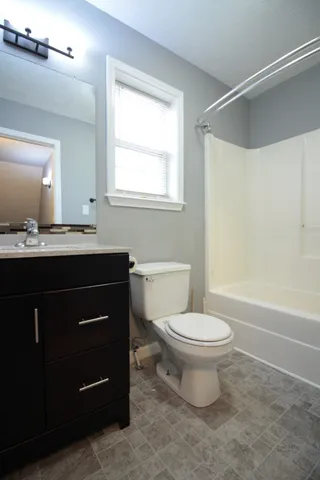 a bathroom with a sink a toilet and a mirror