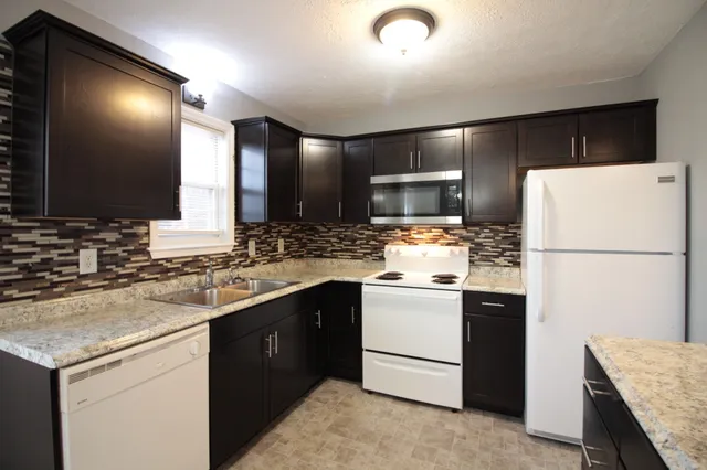 a kitchen with a sink and a refrigerator