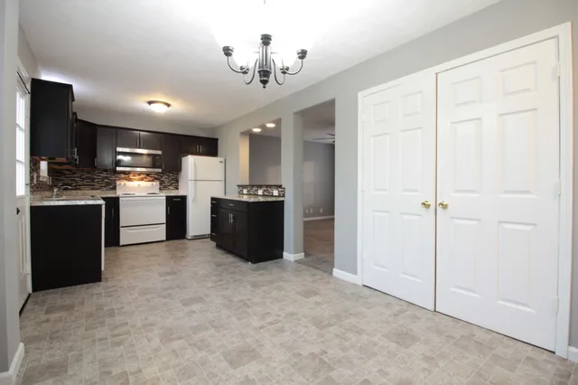 a open kitchen with cabinets and stainless steel appliances