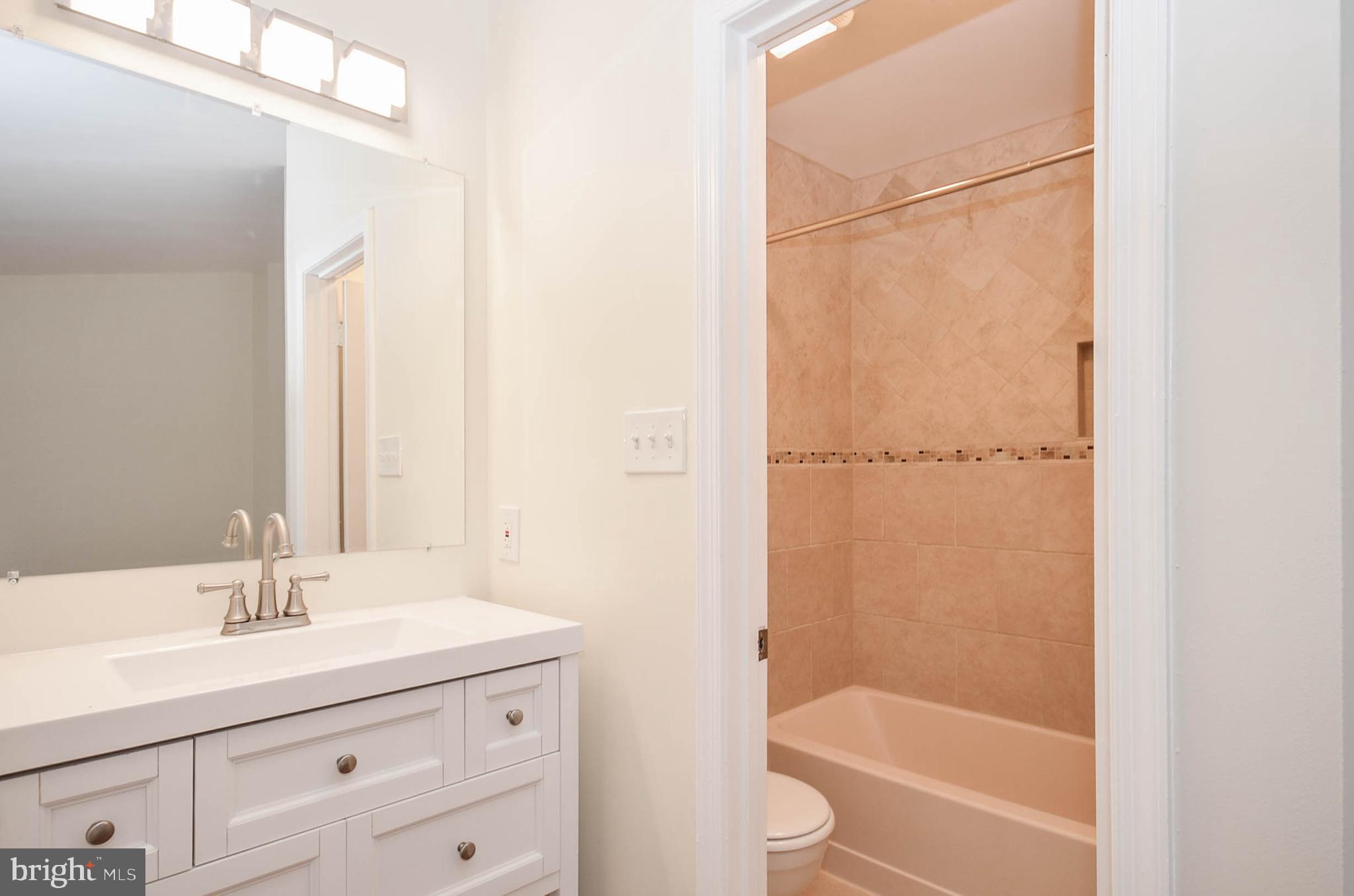 19 Sonata Court Silver Spring, MD 20901 - Photo 15 of 32 Master bath with large vanity and new tile/toilet