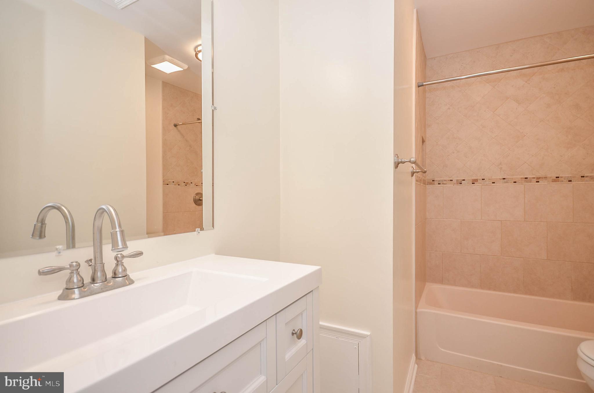 19 Sonata Court Silver Spring, MD 20901 - Photo 18 of 32 Hall Bath with new tile, vanity, faucet, and light