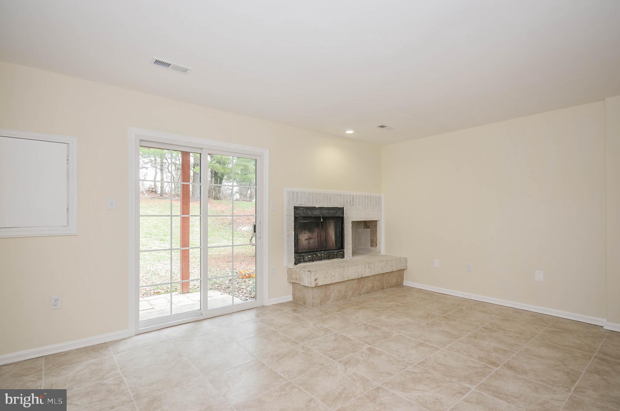 19 Sonata Court Silver Spring, MD 20901 - Photo 22 of 32 Lower level rec room/bedroom with FP & new door