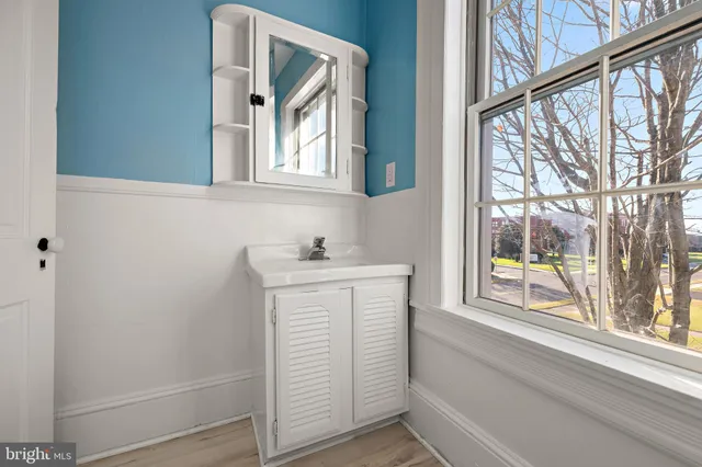 a bathroom with a sink and a window