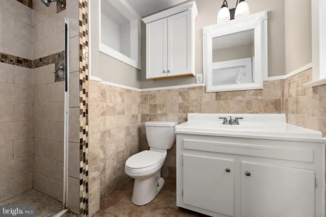 a white toilet sitting next to a bathroom sink