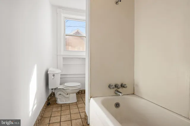 a bathroom with a bathtub and toilet