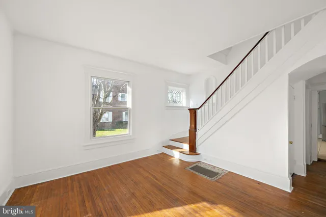 a view of an entryway with wooden floor and door