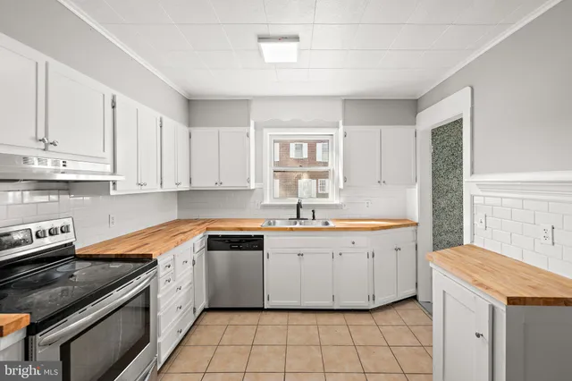 a kitchen with a sink stove and cabinets