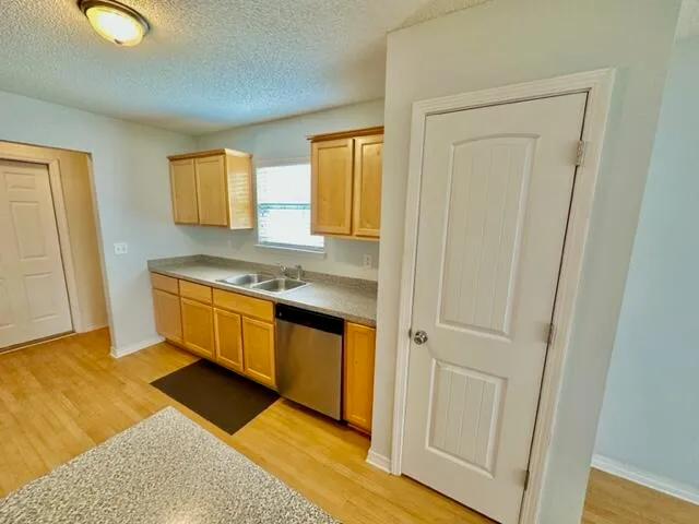a bathroom with a granite countertop sink a toilet and bathtub