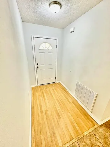 a view of a kitchen with a sink and dishwasher wooden floor
