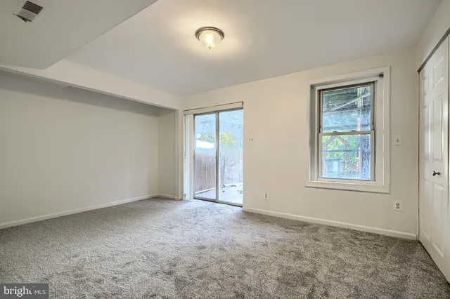 a view of an empty room with a closet