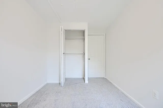 a bathroom with a granite countertop sink mirror vanity and toilet