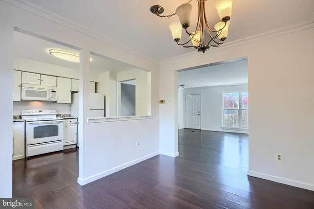 a view of a kitchen with a sink wooden floor and a kitchen view
