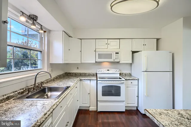 a kitchen with a sink a stove and refrigerator