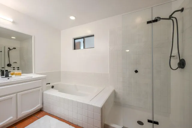 a kitchen with white cabinets and white appliances