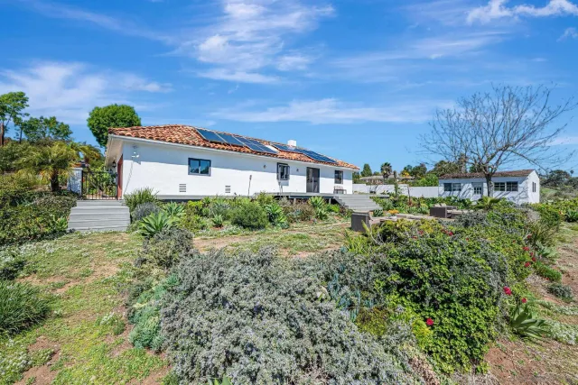 a view of a lake with couches with wooden floor and lake view