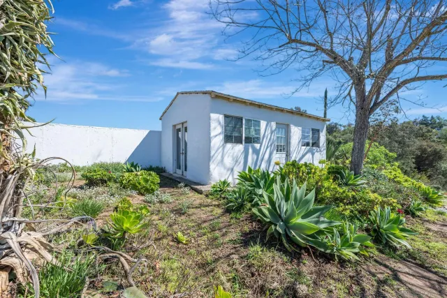 a view of a house with a yard and a garage