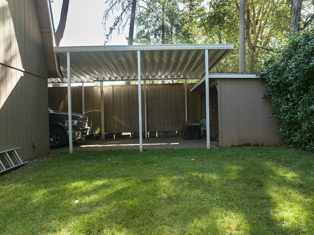 375 Oak Ranch Road Grants Pass, OR 97526 - Photo 44 of 57 a view of a backyard with table and chairs and potted plants